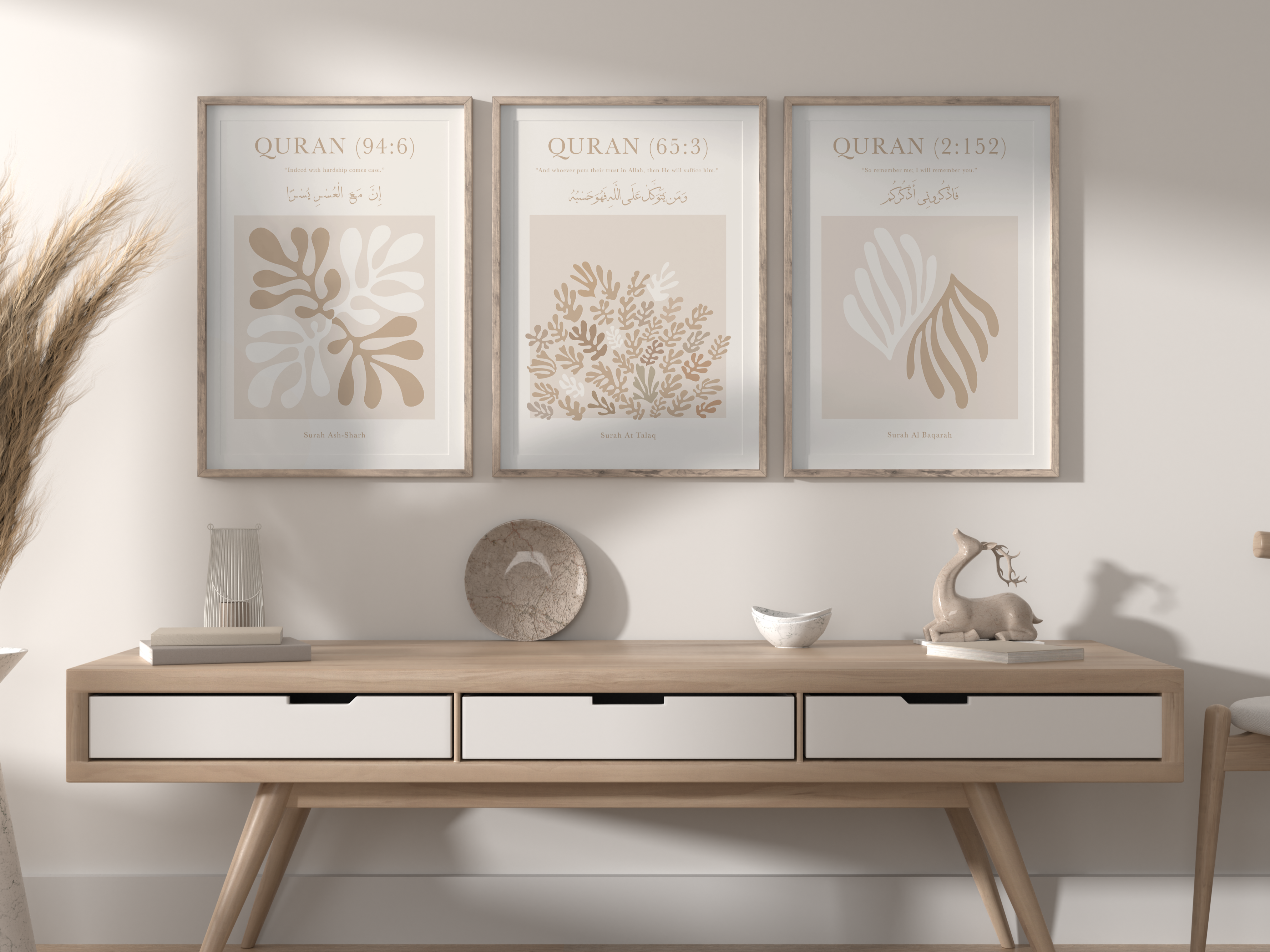 Wooden console table with decorative items against a white wall with framed artwork.